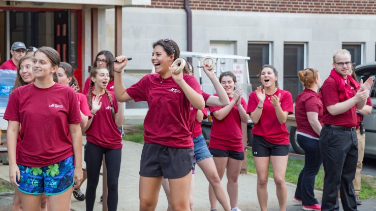 Students volunteering to help with move-in and orientation greet first-years and their families outside of Walz Hall.